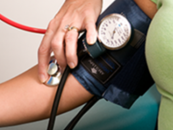 Words reading 'NHS HEALTH CHECK' in blue within a white diagonally positioned box overlaid on a blue background.